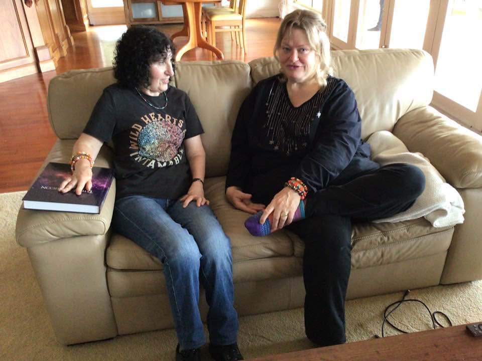 Photo of Jen Ward with a client holding a copy of The SFT Lexicon book