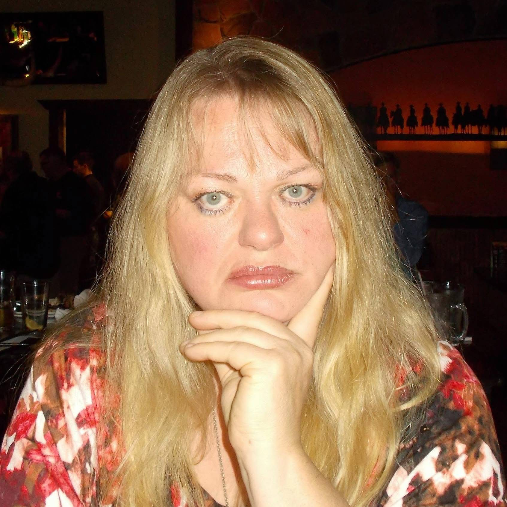 Photo of Jen Ward in the classic Madam Blavatsky pose with finger on the chin