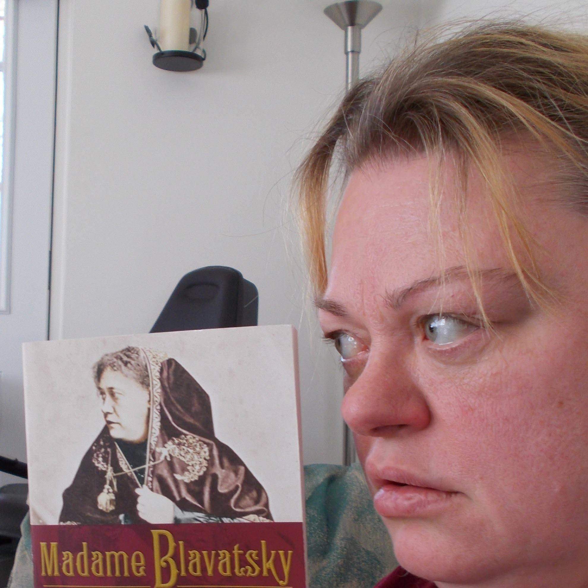 Side profile photo of Jen Ward with Madam Blavatsky book replicating the Blavatsky side profile